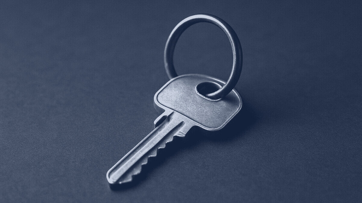 A brass door key on a key ring